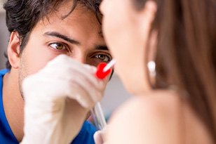 Dentist looking inside a patient’s mouth