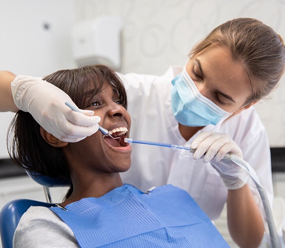 Dentist completing a patient’s teeth cleaning
