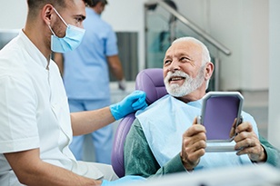 Older couple smiling with dentures
