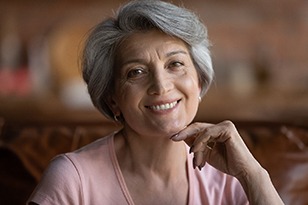 Woman showing off her new set of teeth