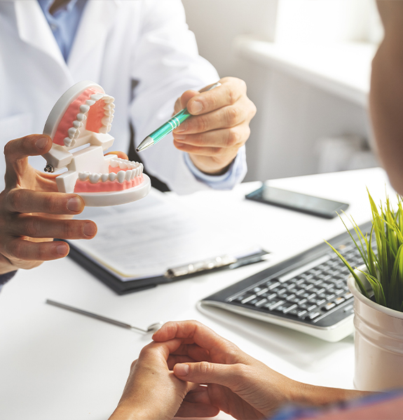 Dentist showing patient a smile model