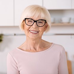 Smiling senior woman enjoying benefits of dental implants
