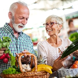 Mature, healthy couple shopping for fruits and vegetables