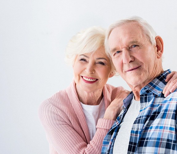 Happy seniors after treatment for failed dental implant in Franklin Park