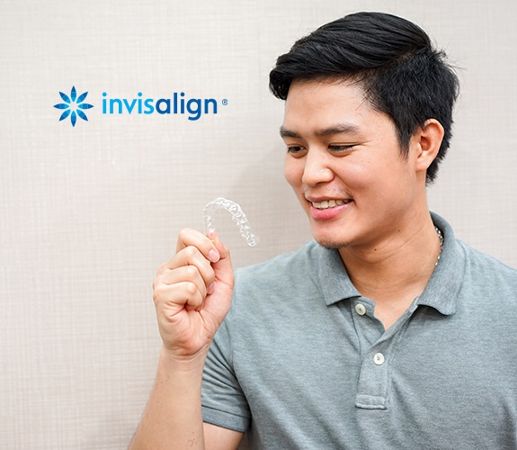 Man holding an Invisalign tray