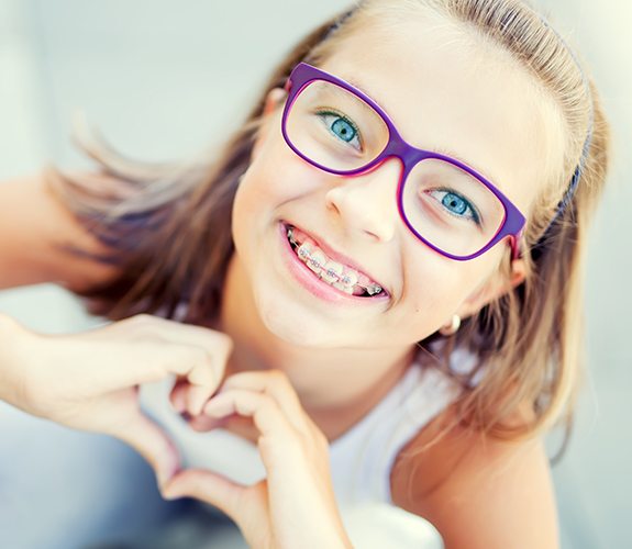 Young girl with traditional metal braces