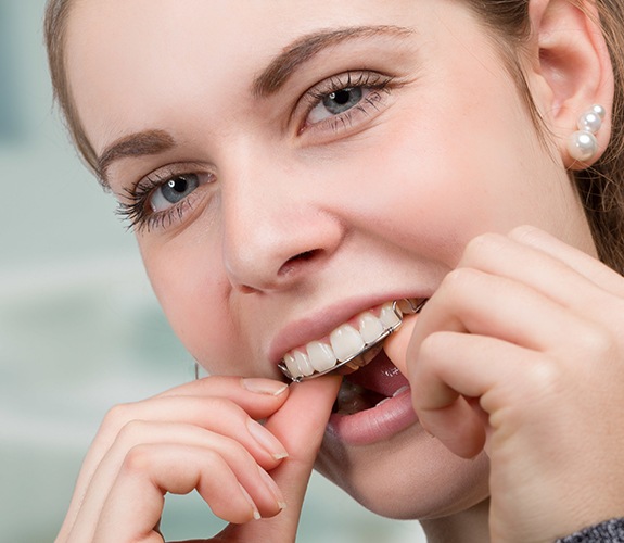 Patient placing orthodontic appliances