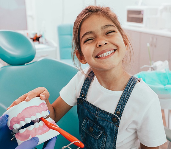 Little boy in dental chair with dentist