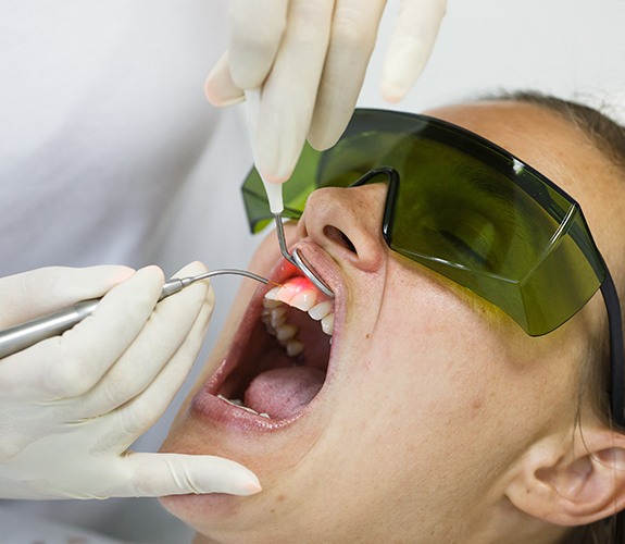 Patient receiving soft tissue laser dentistry treatment