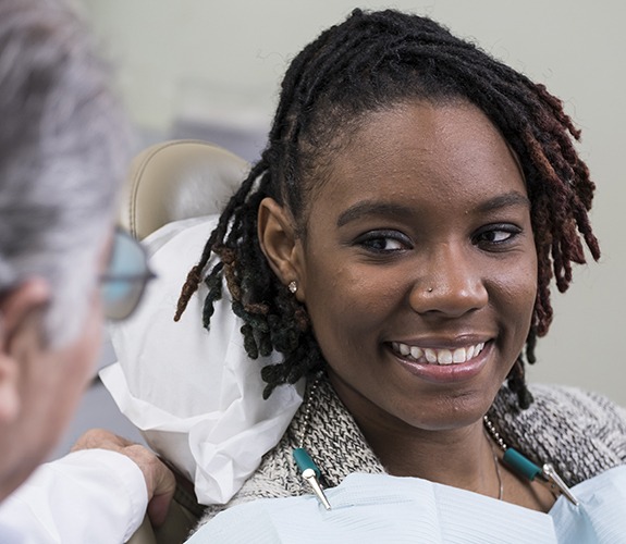 Woman smiling during preventive dentistry checkup