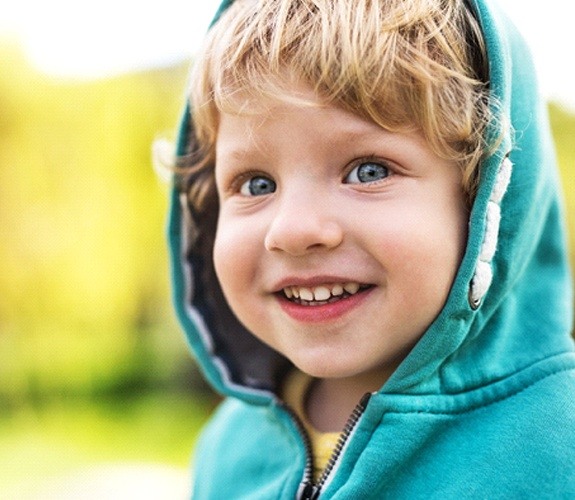 Little girl in dental chair with mouth wide open