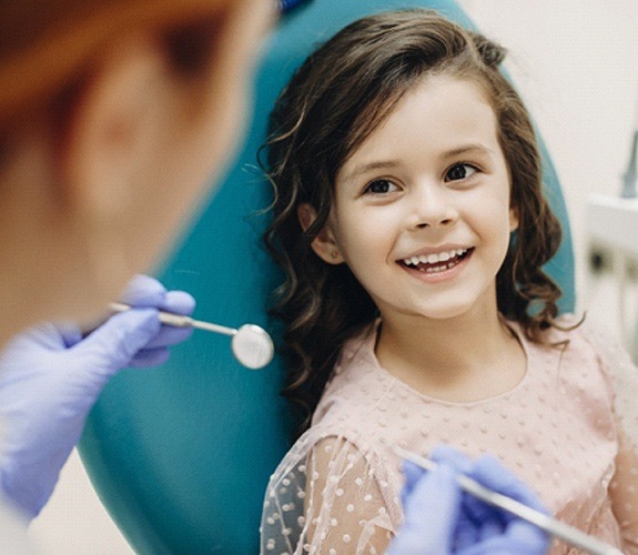 Little girl with tooth pain comforted by mother