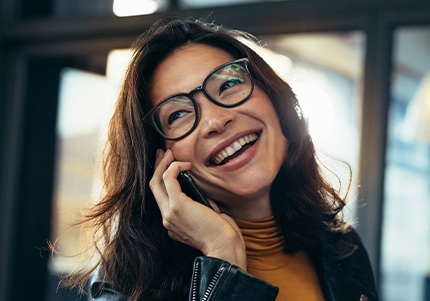 Woman showing off smile after restorative dentistry