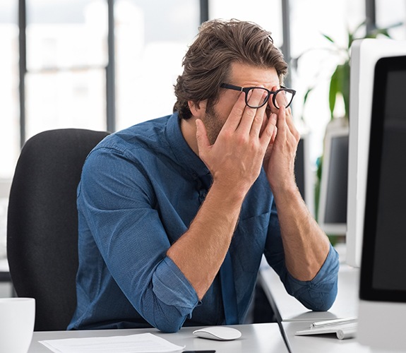 Frustrated exhausted man in need of sleep apnea therapy