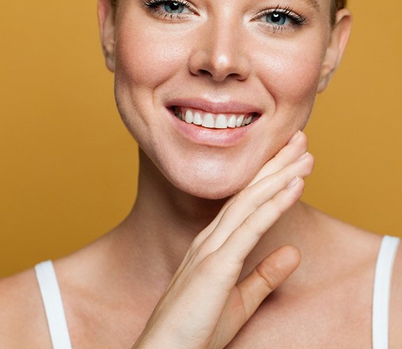 Smiling woman enjoying the benefits of soft tissue laser dentistry