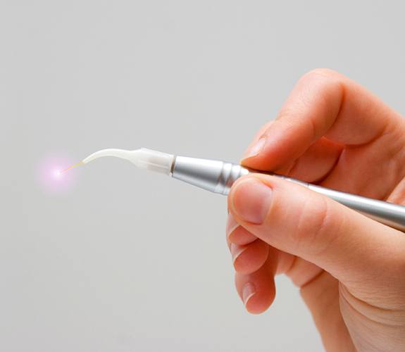 Hand holding soft tissue dental laser