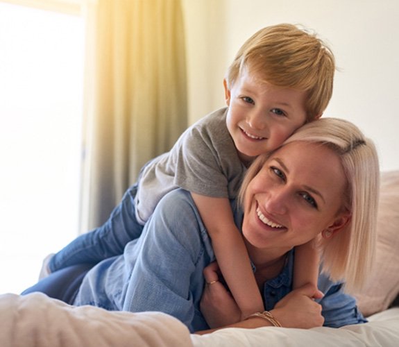 Mother with brighter smile having fun with her son 