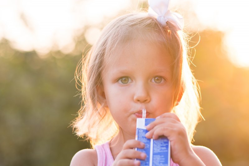 Little girl sipping on a juice box