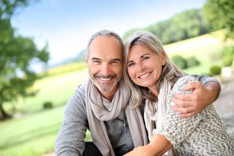 happy couple smiling with dental implants