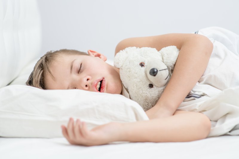 small child asleep with their mouth open