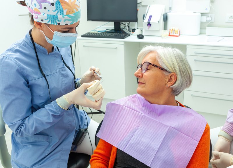 older woman learning about dental implants